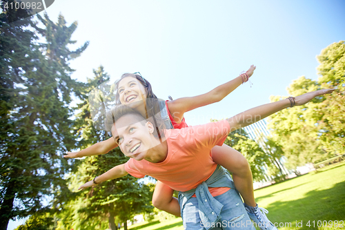 Image of happy teenage couple having fun at summer park