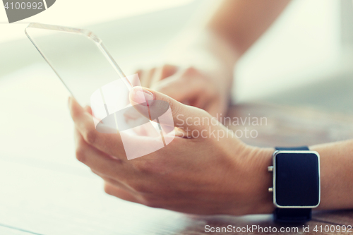 Image of close up of hands with smart phone and watch