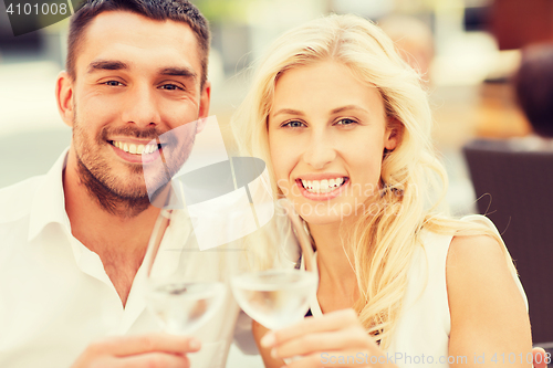 Image of happy couple clinking glasses at restaurant lounge