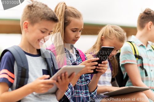 Image of group of happy elementary school students talking