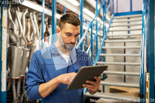 Image of auto mechanic or smith with tablet pc at workshop