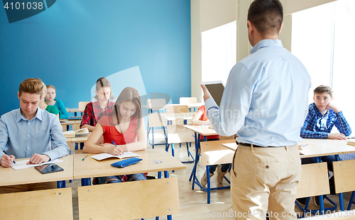 Image of students and teacher with tablet pc at school