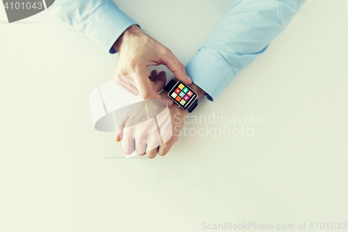 Image of hands with application icons on smart watch