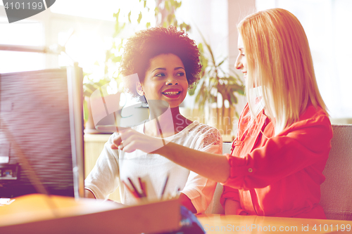 Image of happy women or students with computer in office