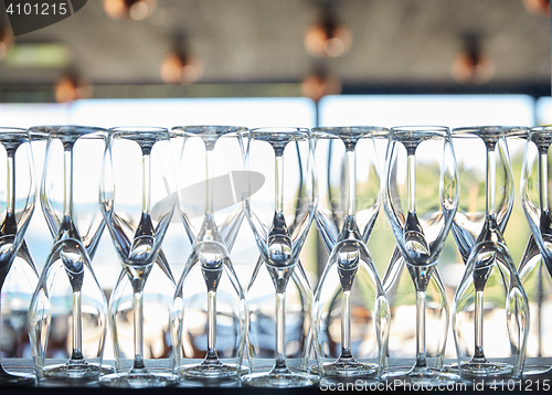 Image of empty wine glasses set on shelf at restaurant