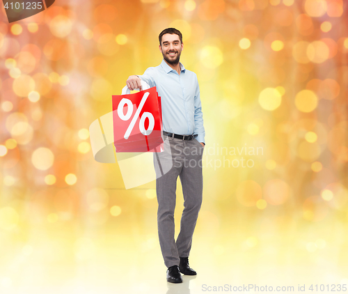 Image of smiling man with red shopping bag