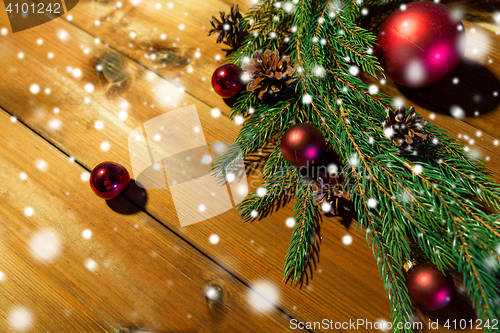 Image of fir branch with christmas ball and pinecones