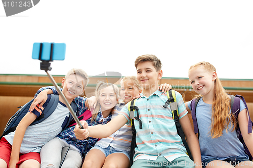 Image of happy elementary school students taking selfie