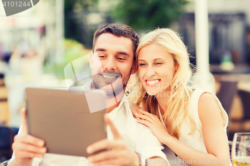 Image of happy couple with tablet pc at restaurant lounge