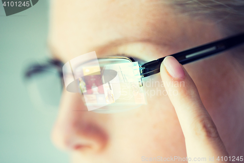 Image of close up of woman in glasses with virtual screen