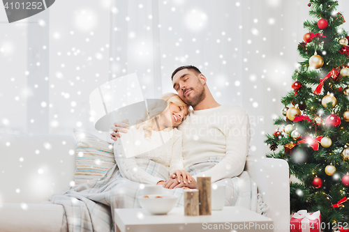 Image of happy couple at home with christmas tree