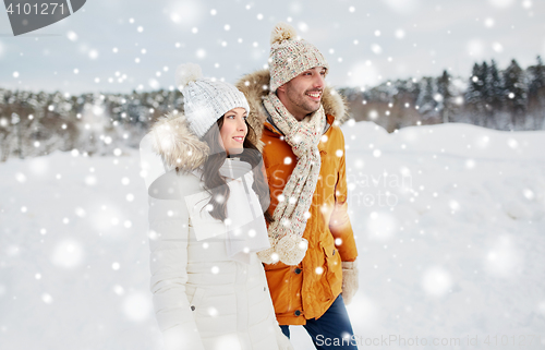 Image of happy couple walking over winter background