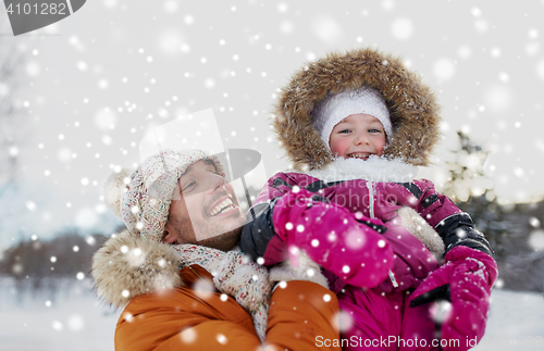 Image of happy family in winter clothes outdoors