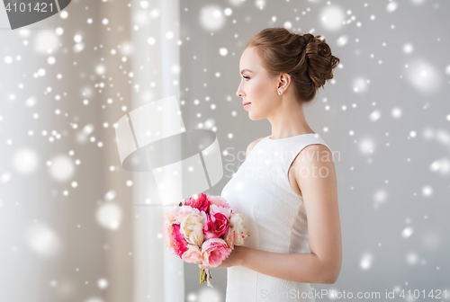 Image of bride or woman in white dress with flower bunch