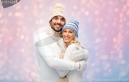 Image of smiling couple in winter clothes hugging