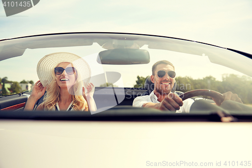 Image of happy man and woman driving in cabriolet car