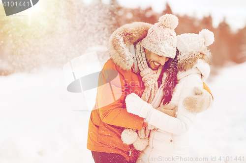 Image of happy couple hugging and laughing in winter