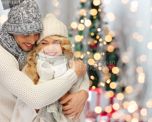 Image of happy family couple in winter clothes hugging