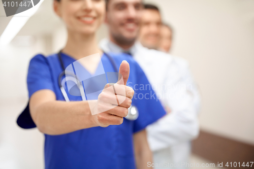 Image of close up of doctors at hospital showing thumbs