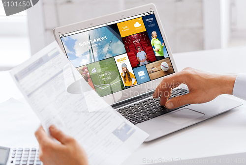 Image of businessman with laptop computer working at office