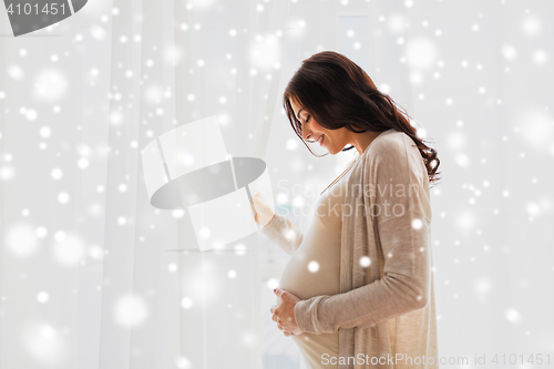 Image of happy pregnant woman with big belly