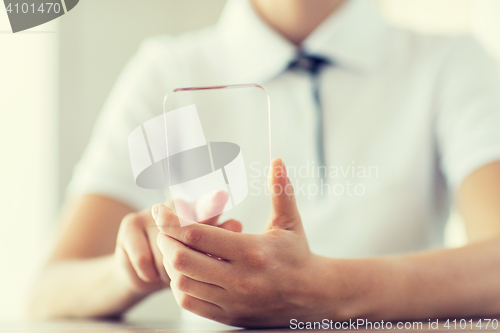 Image of close up of woman with transparent smartphone