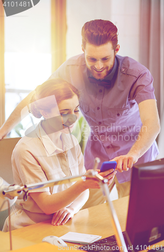 Image of business team with smartphone in office