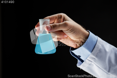 Image of close up of scientist holding flask with chemical