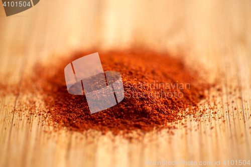 Image of cayenne pepper or paprika powder on wood