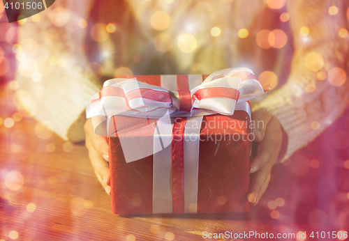 Image of close up of woman with christmas gift