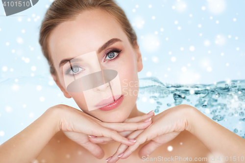 Image of close up of beautiful young woman face over snow