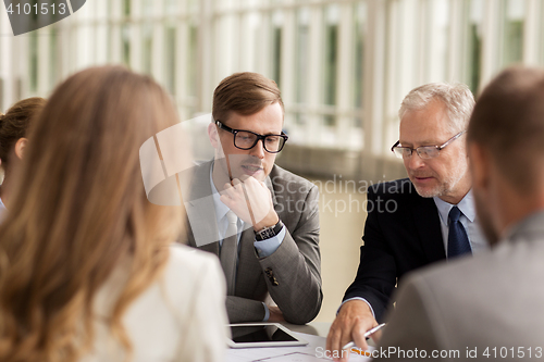 Image of architects with tablet pc and blueprint at office