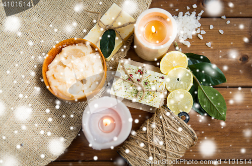 Image of natural soap and candles on wood