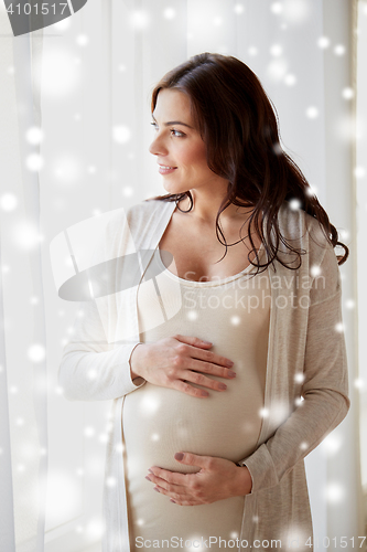 Image of happy pregnant woman with big tummy at home