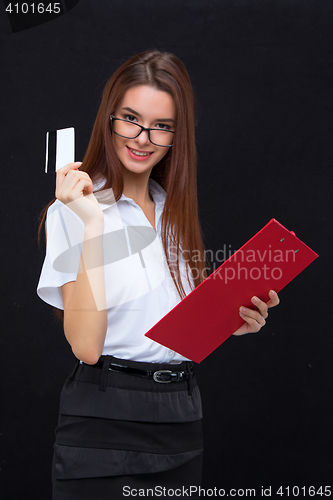 Image of The young business woman with credit card and tablet for notes on gray background