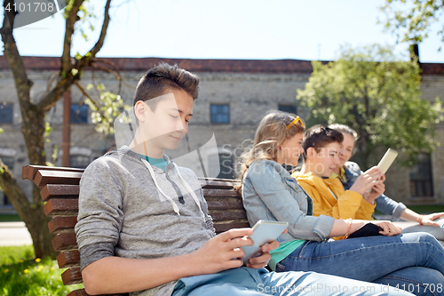 Image of happy friends with tablet pc computer outdoors