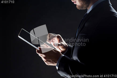 Image of close up of businessman with transparent tablet pc