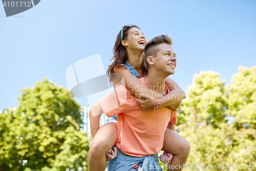 Image of happy teenage couple having fun at summer park