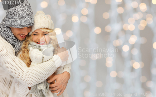 Image of happy family couple in winter clothes hugging