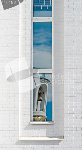 Image of bell-tower reflected at the window
