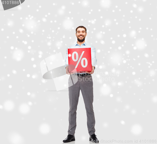 Image of smiling man with red percentage sign over snow