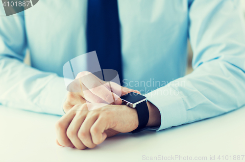 Image of close up of male hands setting smart watch