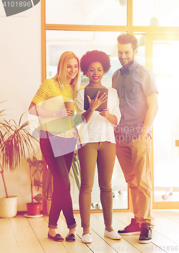 Image of creative team with tablet pc and coffee at office