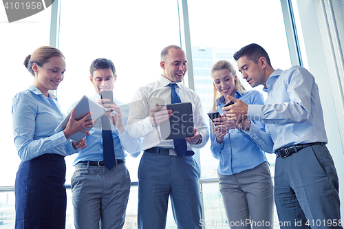 Image of business people with tablet pc and smartphones
