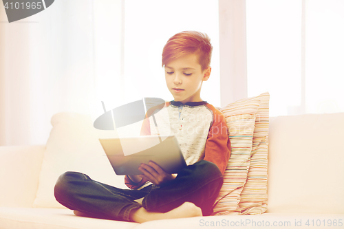 Image of boy with tablet computer at home