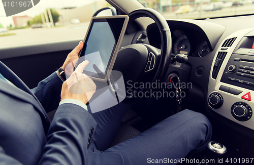 Image of close up of young man with tablet pc driving car