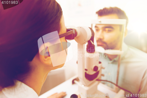 Image of optician with slit lamp and patient at eye clinic