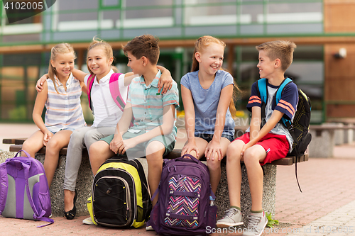 Image of group of happy elementary school students talking