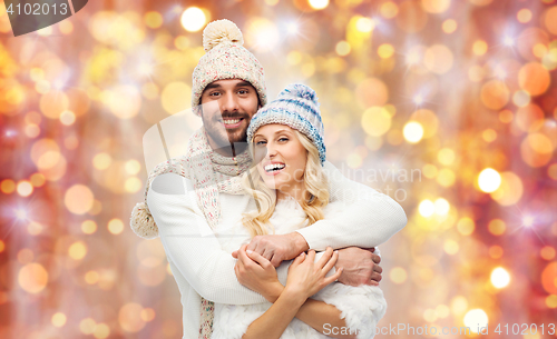 Image of smiling couple in winter clothes hugging