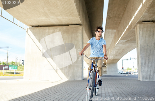 Image of young hipster man riding fixed gear bike